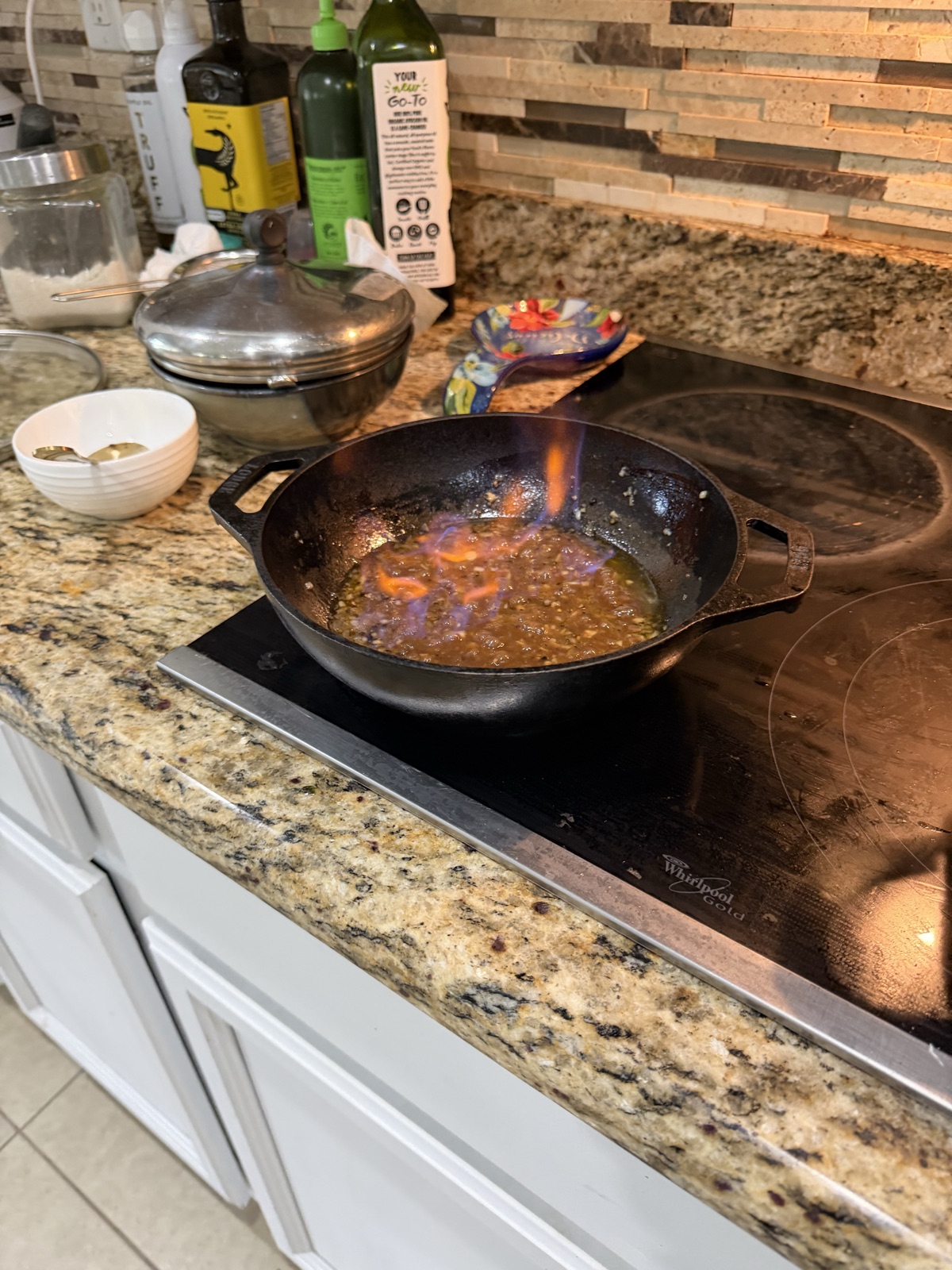 Flambéing the cognac — the cracked peppercorn sauce coming together in cast iron